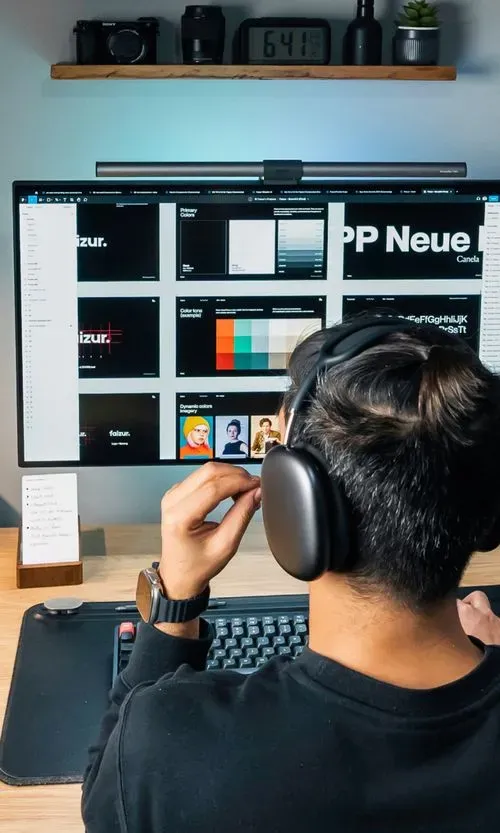 Faizur's desk with a large monitor
